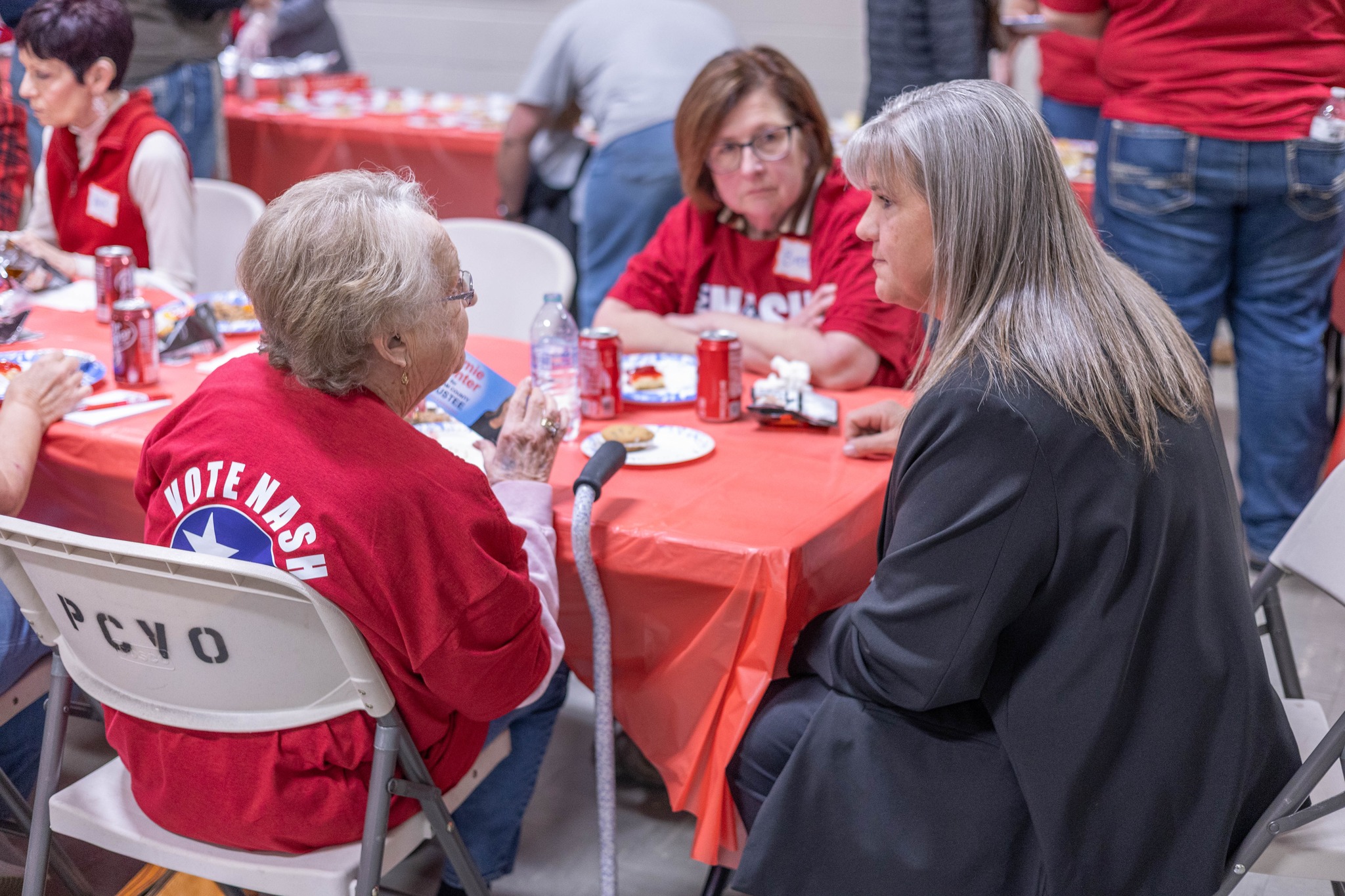 Jamie Hunter speaking one-on-one with a supporter at a campaign event
